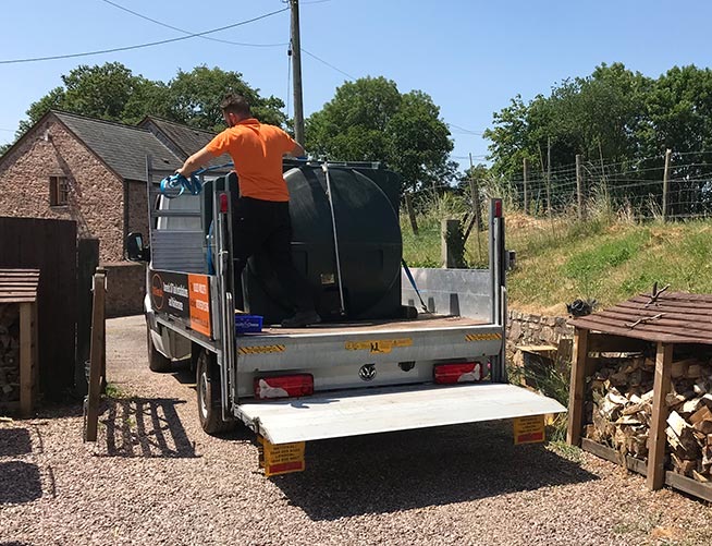 Hendy Hines engineer securing an oil tank on a flatbed truck
